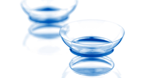 Two contact lenses with reflections, isolated on a white background