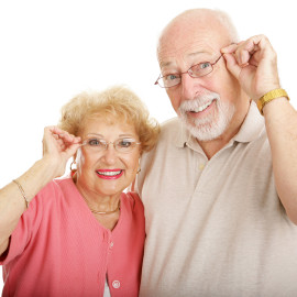 Attractive senior couple wearing glasses.  Isolated on white.